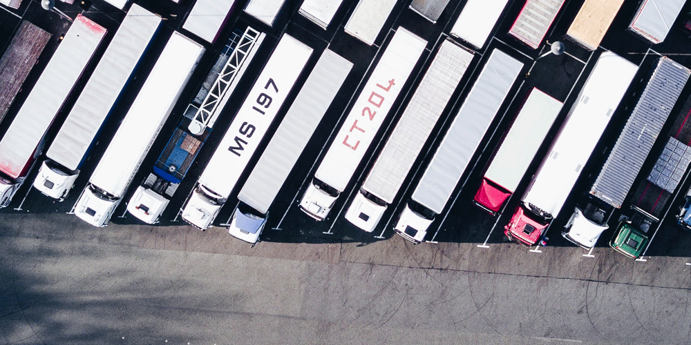 Aerial view of a crowded lot full of semi-trucks.