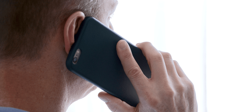 Man holding cell phone up to ear, how to stand out as a truck driver