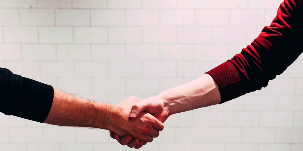 Two people shaking hands.