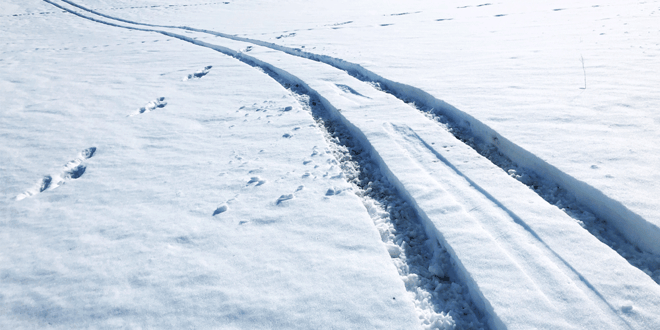 Truck tire chain tracks in deep snow; semi-truck tire chain laws by state; Anderson Trucking Service; ATS