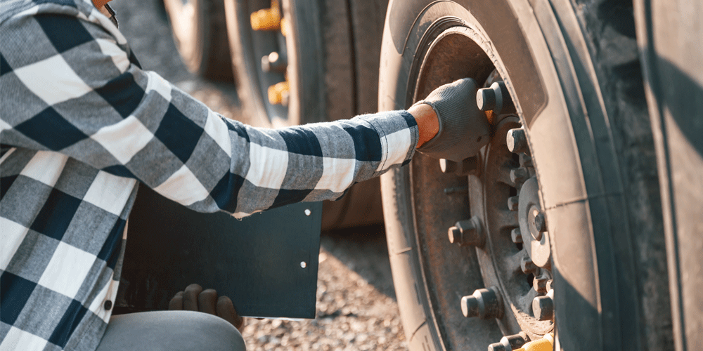 Driver tugging on lug nuts.