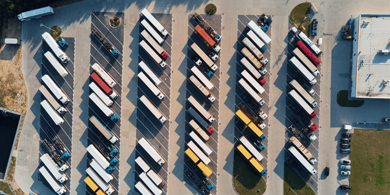 Aerial view of a full truck stop parking lot, Anderson Trucking Service