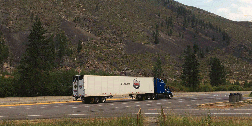 ATS dry van truck parked in the middle of nowhere.