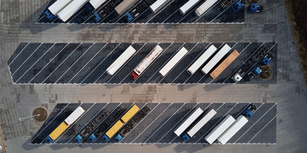 Bird's eye view of a parking lot with semi-trucks parked.