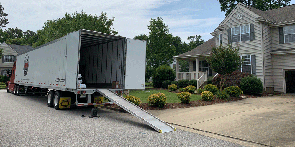 Unloading a dry van in front of a residential area. 