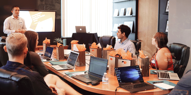 Group of team members in a conference room completing a training session, what is a driver manager, ATS, trucking
