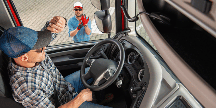 Driver in his truck talking to his fleet manager standing outside his truck, ATS, Anderson Trucking Service, driver orientation