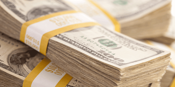 Stacks of hundred dollar bills. Why DOD drivers earn more