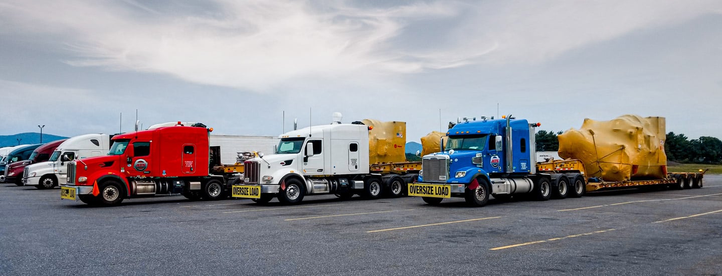 A lineup of trucks carrying oversize loads.