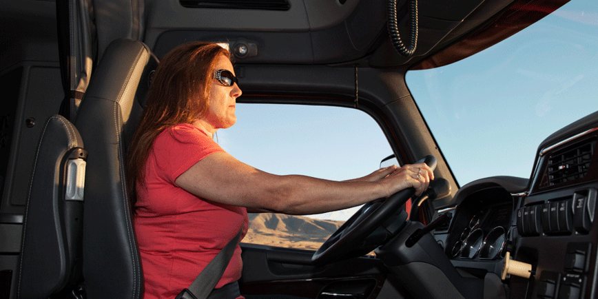 Woman truck driver behind the wheel