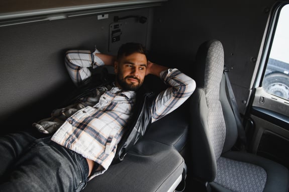bearded-man-resting-in-a-semi-truck-cabin, what are recap hours in trucking, Anderson Trucking Service