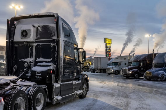 Semi-truck parked at a cold truck stop with nearby idling trucks; ATS; How an APU works