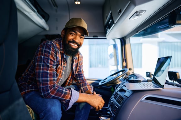 smiling-truck-driver-in-the-cab-of-vehicle-2026-03-17-07-06-35-utc. Companies for new drivers in 2026
